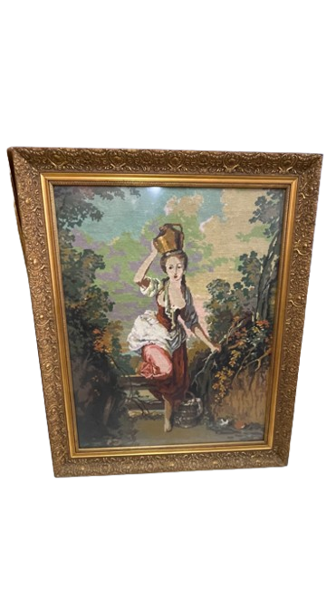 Punto de cruz de una mujer con cántaro en paisaje rural